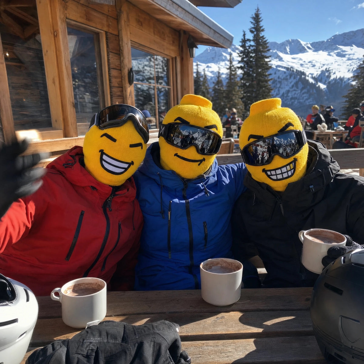 Three friends in Balakoo ski masks with hot chocolate on a chalet terrace
